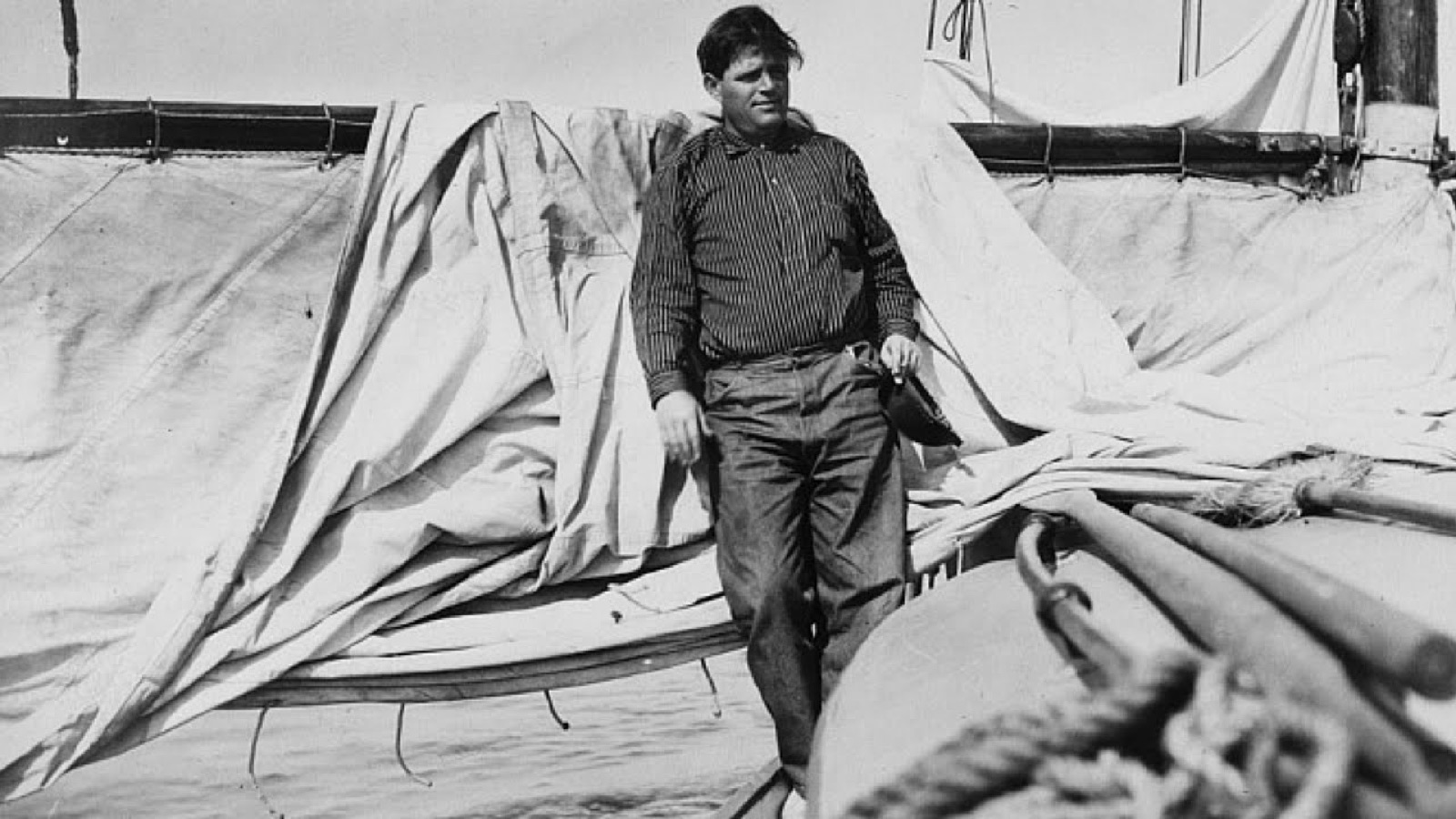 Jack London standing on the deck of a sailing ship